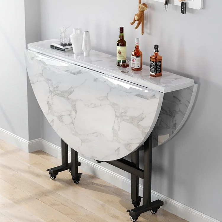Tavolo da pranzo moderno pieghevole con piano rotondo legno e gambe metallo Clearhalo