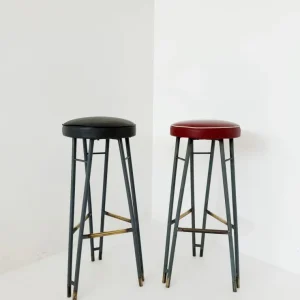 Una coppia di sgabelli alti con struttura metallo verniciato, caratterizzati da un design elegante